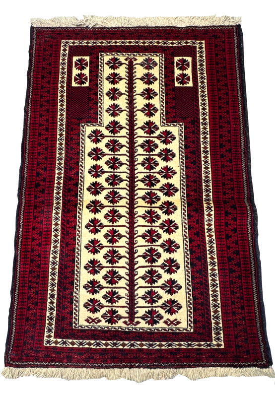 Persian Baluch tribal prayer rug laid flat showing stepped mihrab arch and tree of life on ivory field