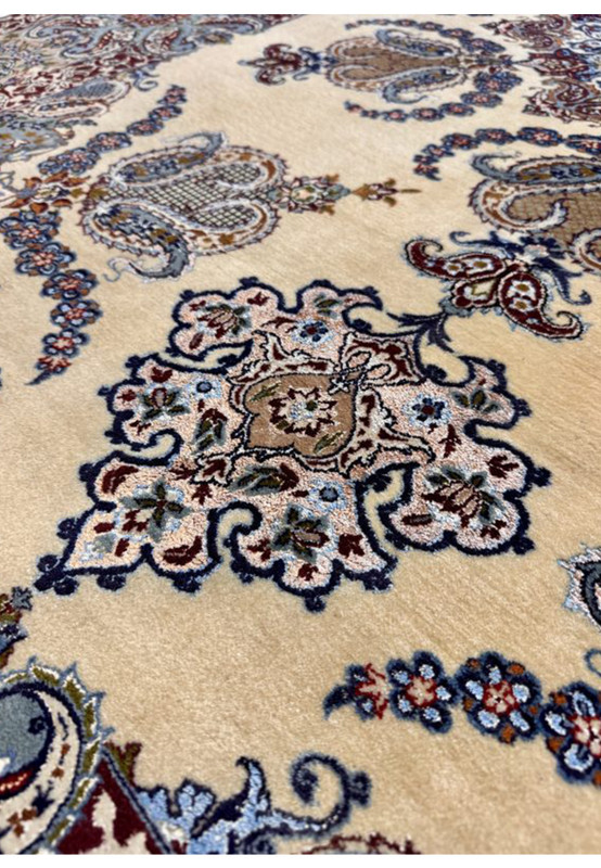 Detailed pattern shot of paisley boteh and floral motifs on ivory Persian Isfahan rug field