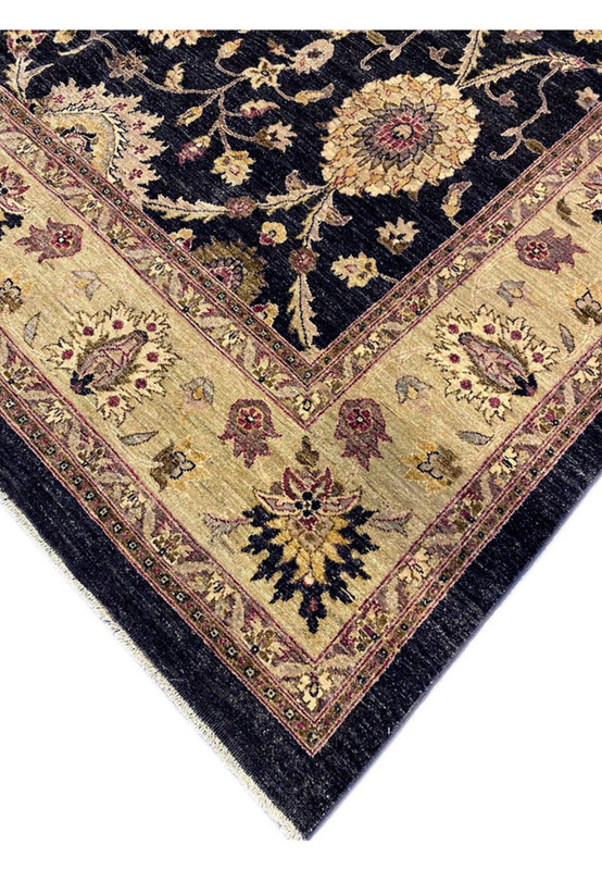 Edge and corner detail of authentic Oriental Agra rug with antique gold border on deep black ground