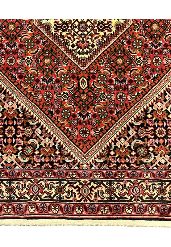 Lower border detail with turtle palmettes on cream ground above the natural cotton fringe