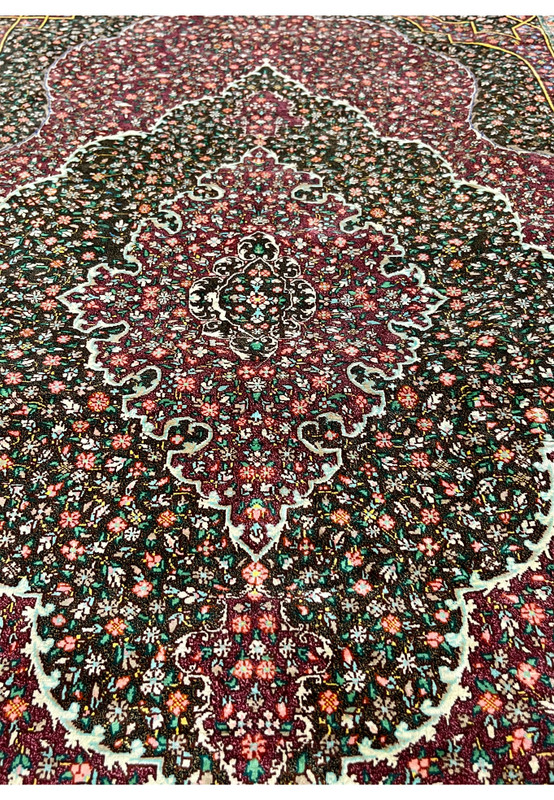 Midfield detail of the pure silk pile showing the painterly density of floral motifs