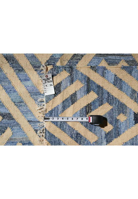 Backside view of the 9 x 12 hand-woven cotton kilim showing the clean reverse weave and labeled rug tag