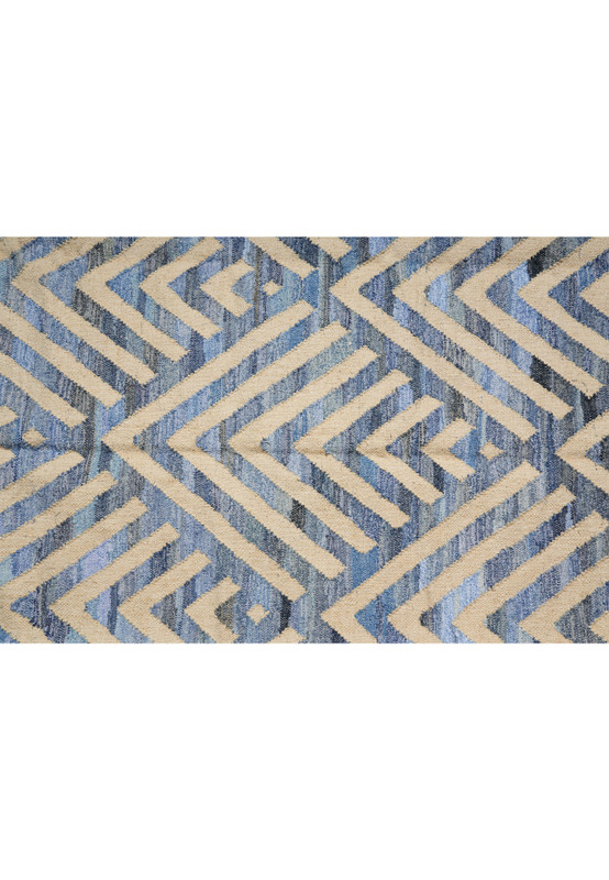 Pattern detail of nested chevrons and concentric diamonds in chambray, slate, and indigo blues against cream cotton