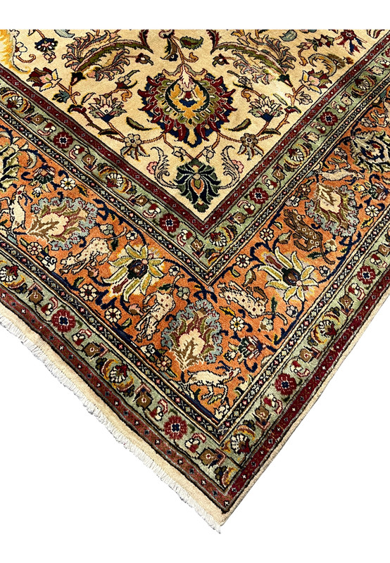 Border corner detail showing the sage green guard borders reciprocal floral cartouches and the precision of Tabriz drawing