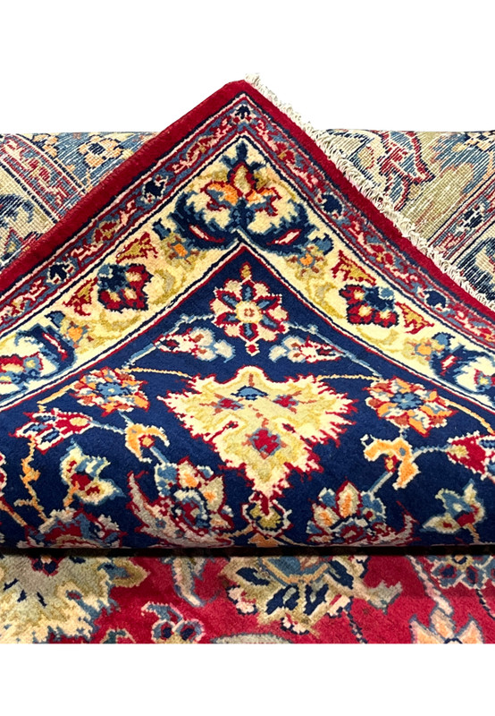 Folded edge of Persian Isfahan rug showing structural integrity and even pile height across the field
