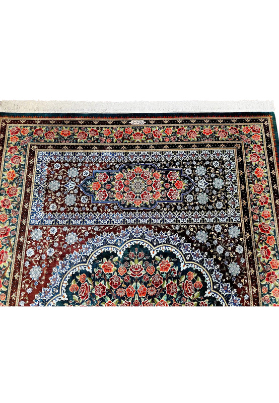 Persian Qum silk on silk rug shown from a low angle, scalloped medallion glowing against deep oxblood and navy ground