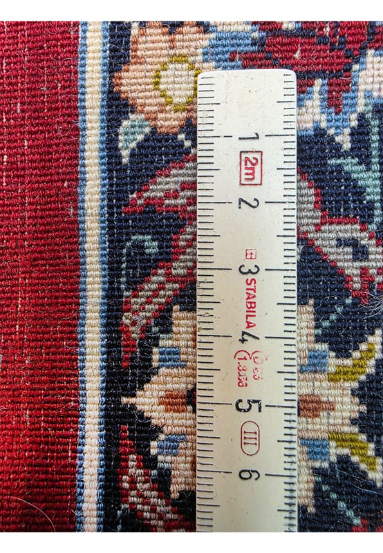 Backside knot density measurement showing approximately 700 KPSI on signed Ahmad Zojaji Persian Isfahan square rug