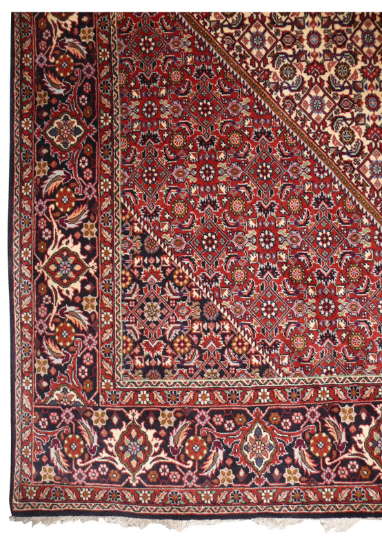 Corner detail of 7x10 Persian Bijar with brick red spandrel meeting navy palmette border and ivory guard stripes