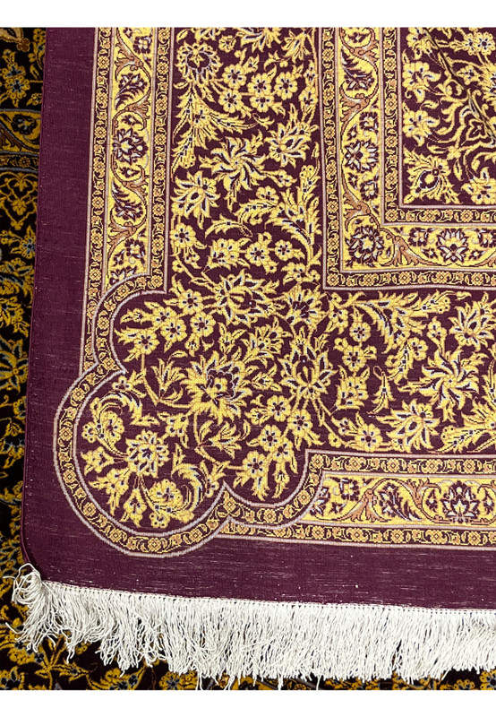 Backside view of signed Naimi Persian Qum silk rug showing fine knot grid and magenta ground from the reverse