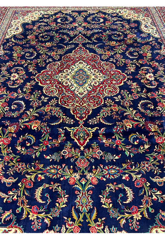 Mid-field detail of 10x13 Qum kork rug, free flowing floral sprays and curling vines drawn across midnight navy ground