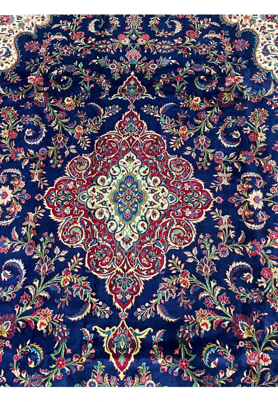 Central layered medallion of Persian Qum kork rug, teal blue starburst core surrounded by ivory cartouche and crimson palmette tiers