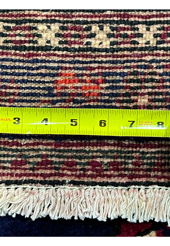 Backside knot density measured on Persian Meymeh, ruler showing tight knot count, 220 to 240 KPSI hand-knotted wool