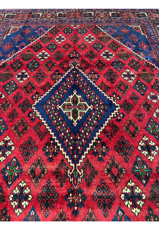 Central navy diamond medallion of authentic Persian Meymeh rug, ivory four-petal rosette, stepped ivory outline