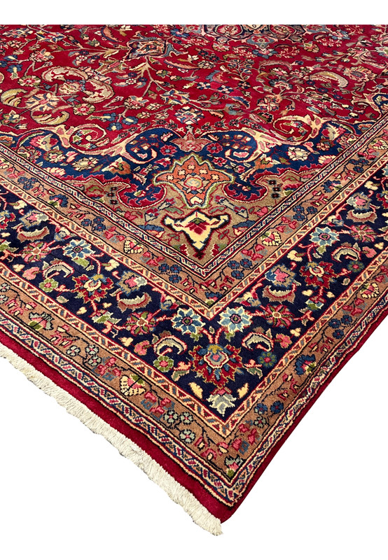 Edge of 10x13 Persian Mashad, navy main border with caramel inner band, ivory fringe, hand-knotted wool on cotton