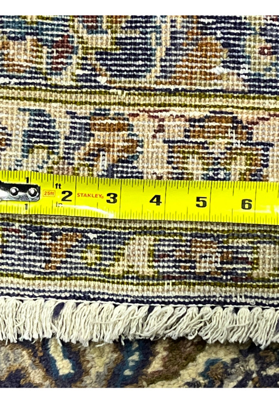 Backside knot density measured on Persian Kashan rug, ruler showing fine knot count, 200 to 240 KPSI hand-knotted wool