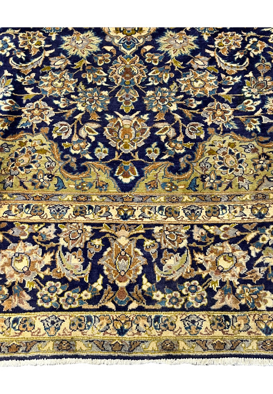 Lower border of 10x13 Persian Kashan, navy band with ivory palmettes and salmon accents, ivory guard, dining room rug