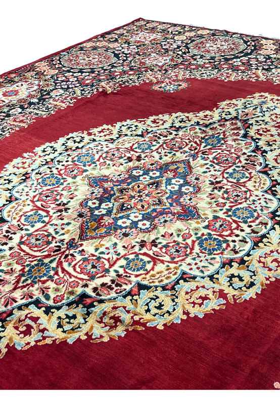 Central medallion close-up of fine Moud rug, ivory cartouche with floral arabesque and navy inner core, master workshop