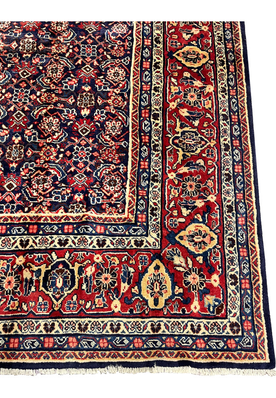 Border close-up of Persian Mahal rug, red ground with ivory and gold floral cartouches, classical Sultanabad workshop weaving