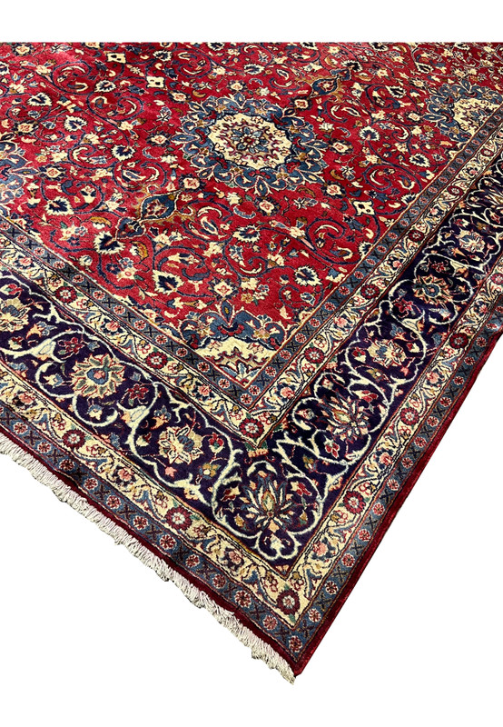 Corner edge of 9x13 Persian Isfahan rug, intact selvedge and crisp navy guard borders, never used handmade wool rug