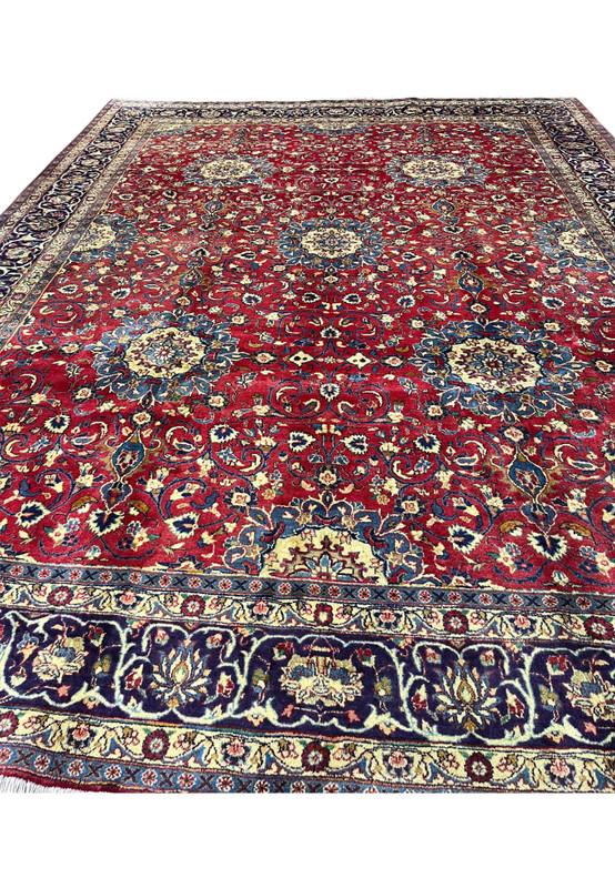 Deep red Persian Isfahan rug top view, ivory rosettes and scrolling vines on ruby ground, authentic hand-knotted workshop weave