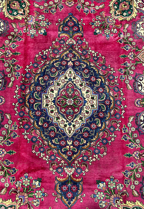 Central medallion of Persian Kerman rug, deep navy diamond with serrated edge and ivory floral cartouche, authentic handmade workshop weave