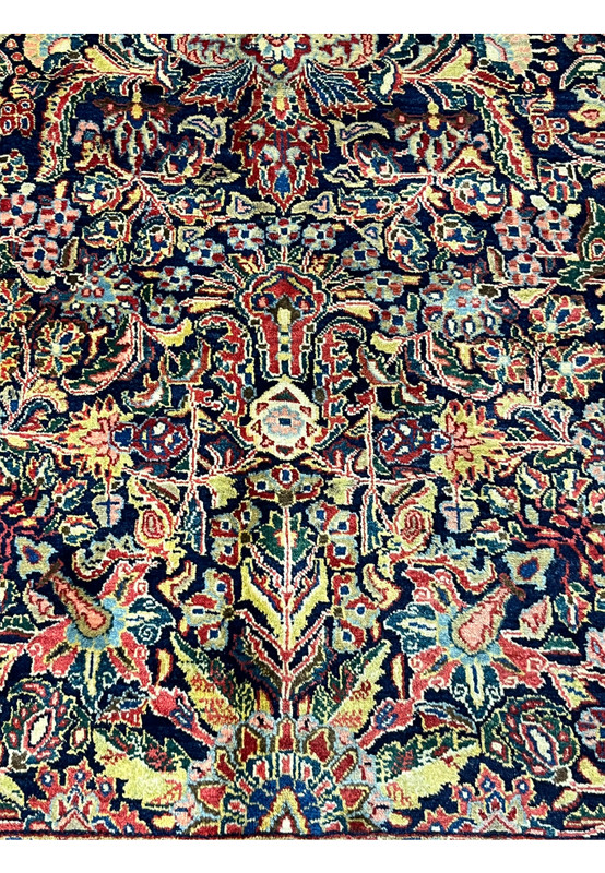 Navy field pattern close-up showing weeping boteh and cypress-like terminals on antique Sarough rug