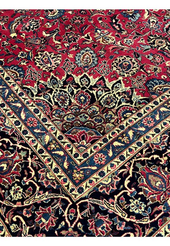 Inner border detail of vintage Mashad rug, navy ground with rose palmettes and ivory rosette guard stripes