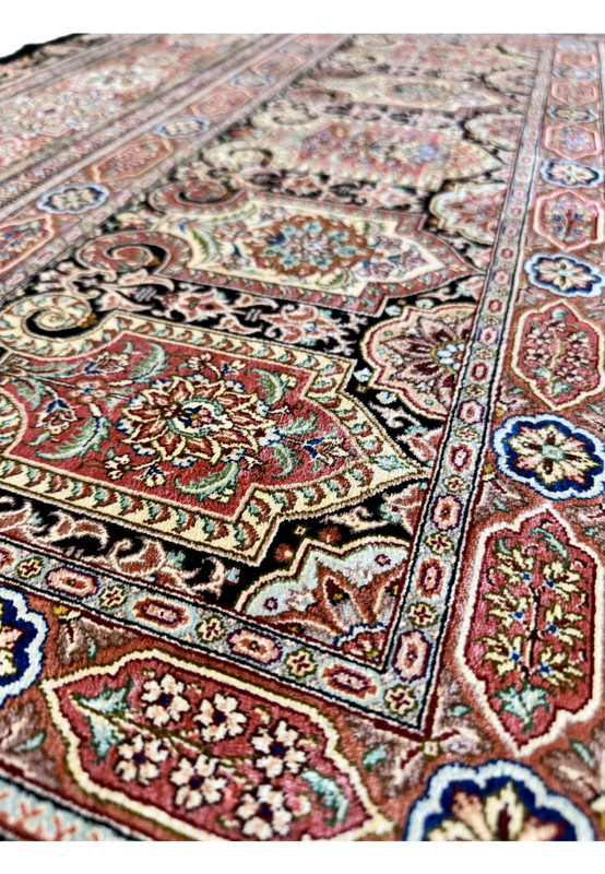 Pattern detail of master signed Qum silk rug, densely drawn floral panels in terracotta salmon and royal blue