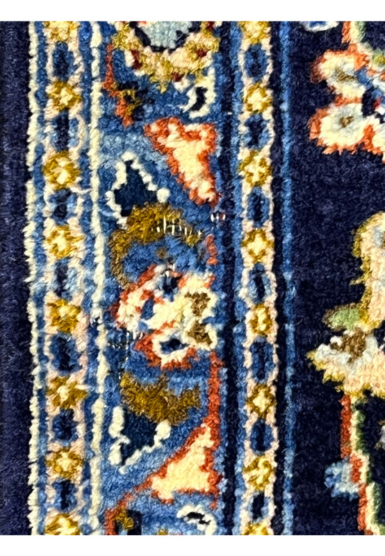 Low pile detail on navy Persian Kashan rug, a minor area documented honestly in close-up