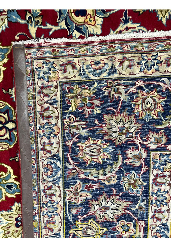 Backside of hand-knotted Persian Najafabad rug showing tight weave and crisp red floral pattern
