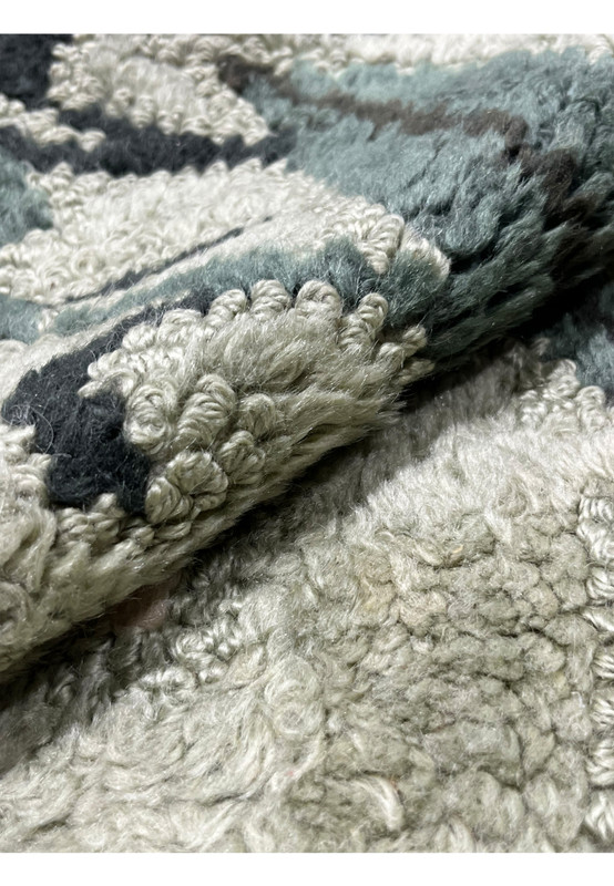 Rolled view of 6x9 vintage hand-hooked rug showing thick sage green looped wool pile