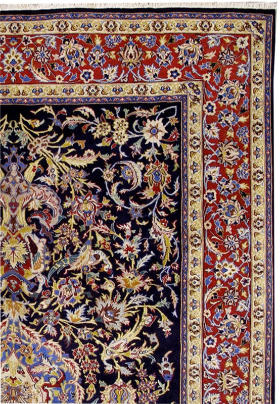 Border detail of Persian Isfahan wool and silk rug, red ground with blue and ivory florals