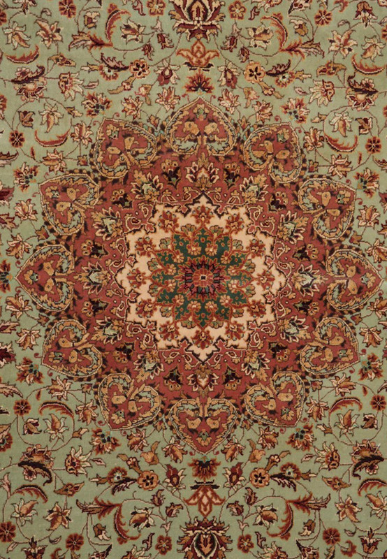 Center star medallion of Persian Isfahan rug, rose and ivory on a sage-green field