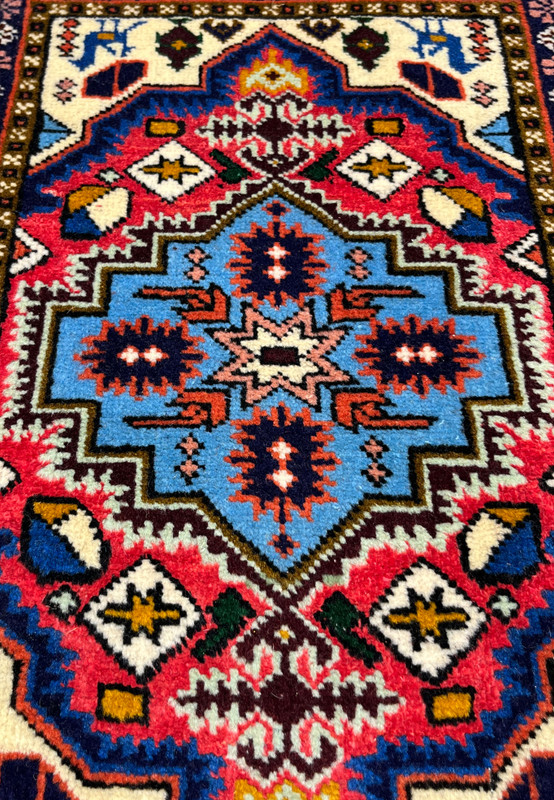 Close-up showing raspberry red and sky-blue color saturation, Persian Ardebil baby rug wool and silk 250 KPSI