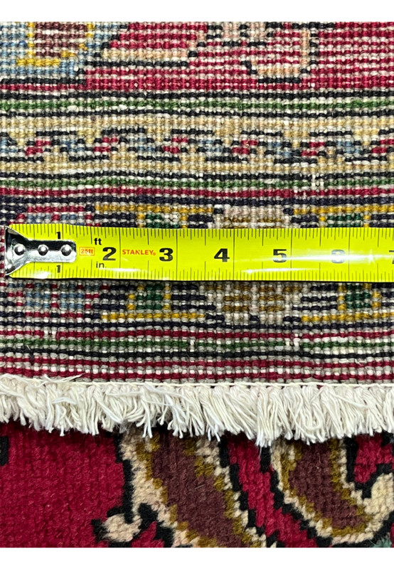 Knot density tape measurement on reverse of Persian Tabriz rug confirming 160 to 180 KPSI hand-knotted weave