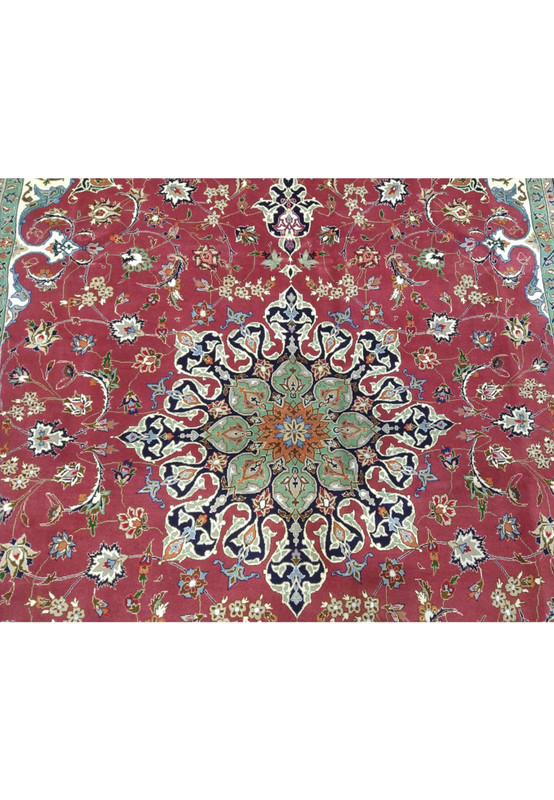 Central medallion closeup of Persian Tabriz 60 raj rug, sage and mint star burst on navy with sky blue and tan core