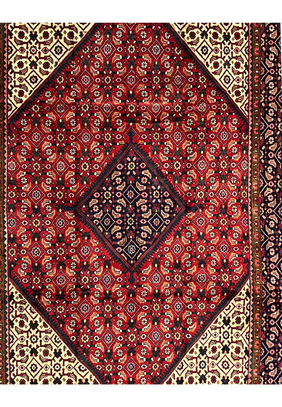 Central navy diamond medallion framed by an all-over Herati field of rosettes on deep red wool