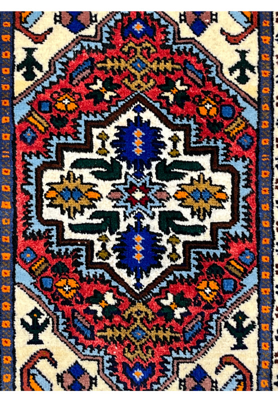 Stepped ivory medallion with a sky blue star, navy cartouches and emerald leaf forms in silk