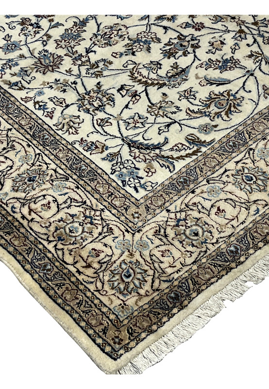 Border and field corner of the Nain rug with fine vine scrolls and visible tonal discoloration