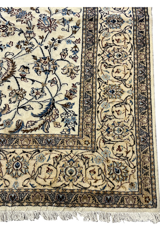 Corner detail showing ivory border tracery, blue guard stripes and discoloration along the edge