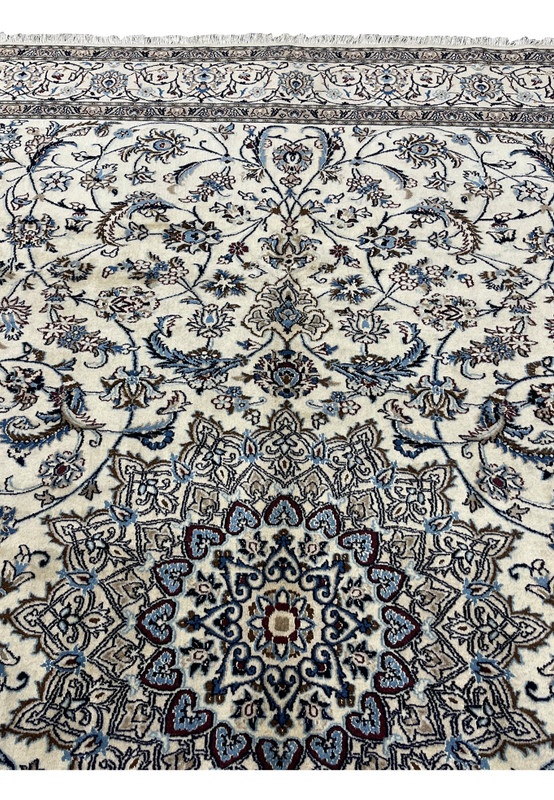 Close view of the medallion and surrounding Shah Abbasi palmettes in light blue, navy and brown