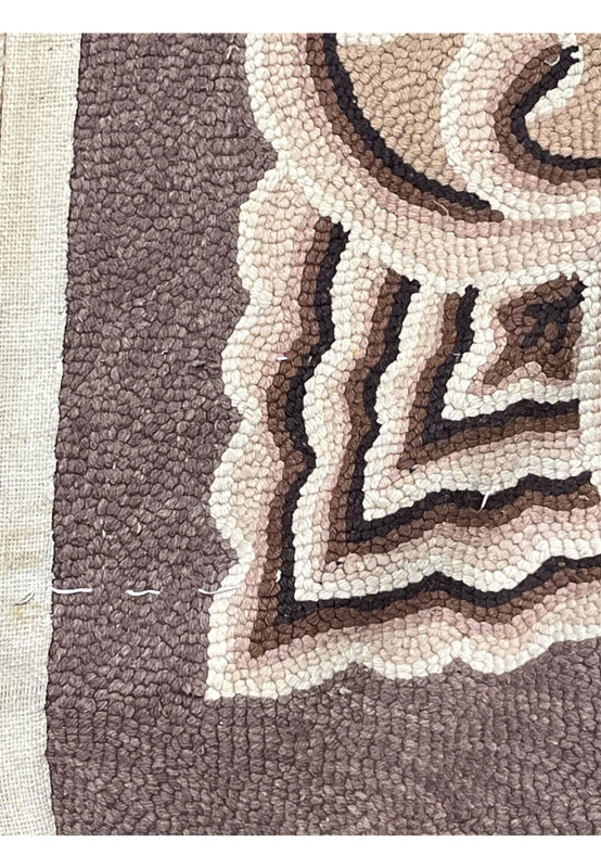 Edge detail showing the cotton base cloth and looped wool pile along the deep brown border
