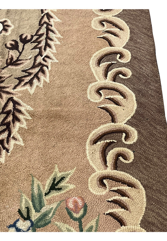 Border detail showing cream acanthus scrolls and a brown leaf wreath against the taupe wool ground