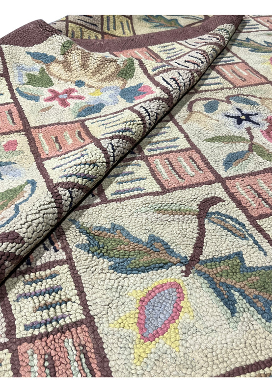 Folded section of the Oriental hook rug revealing the thick hand looped wool surface