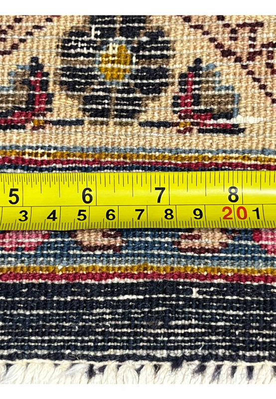 Tape measure across the back knots confirming the fine 180 to 200 KPSI Mashad weave