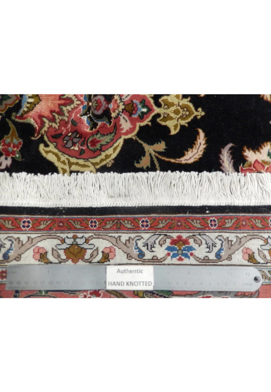 Reverse of the wool and silk Tabriz with ruler across the fine 400 KPSI knotting