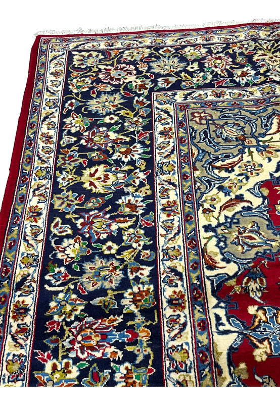 Corner detail of the oversized Persian rug showing border system and sage spandrel