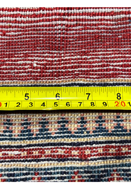 Backside with tape measure across the fine 160 to 180 KPSI hand-tied knots