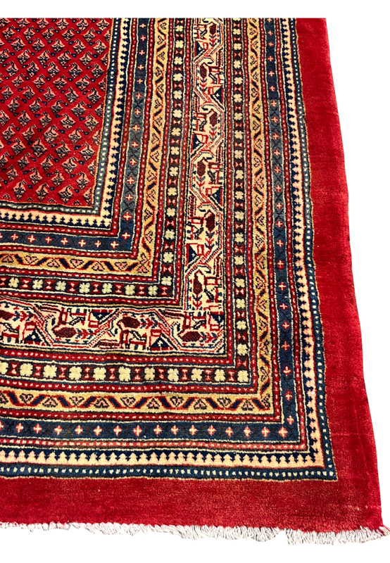 Multi stripe border with ivory camel band navy and gold guard stripes on the red rug