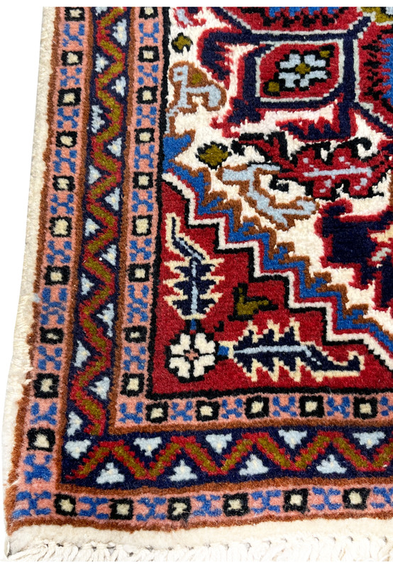 Closeup of the salmon main border with geometric meander and blue box guard bands